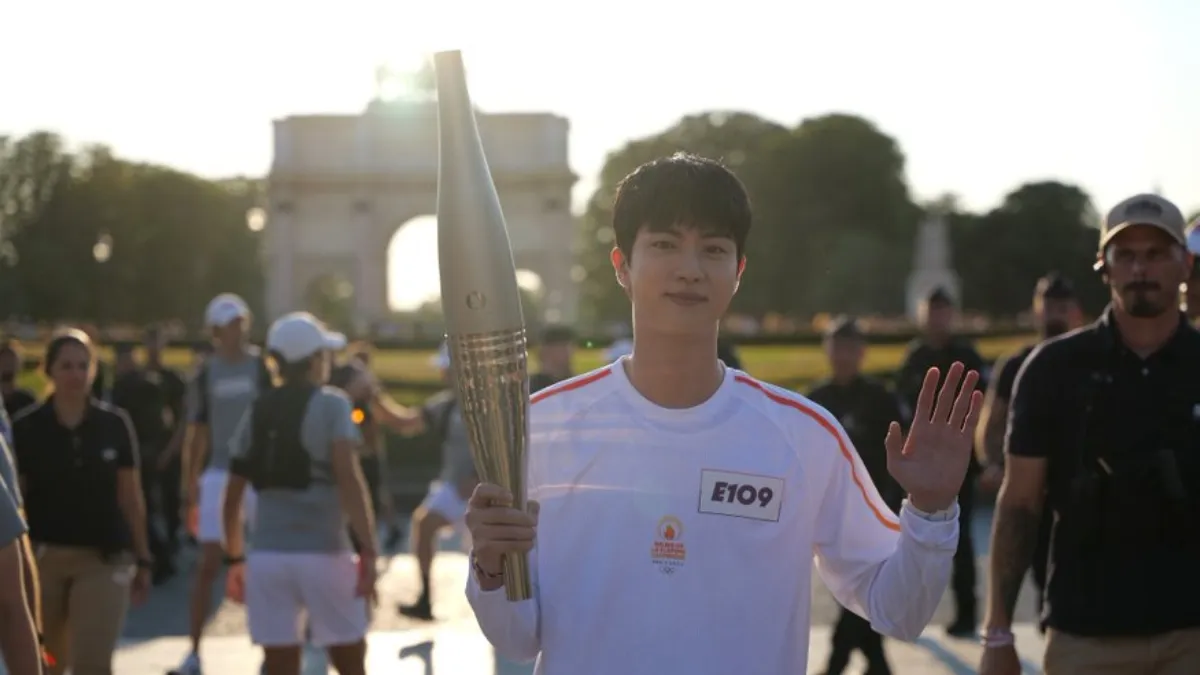 bts-jin-gives-heartwarming-reaction-after-his-song-super-tuna-plays-during-2024-paris-olympics-torch-bearing-ceremony-watch